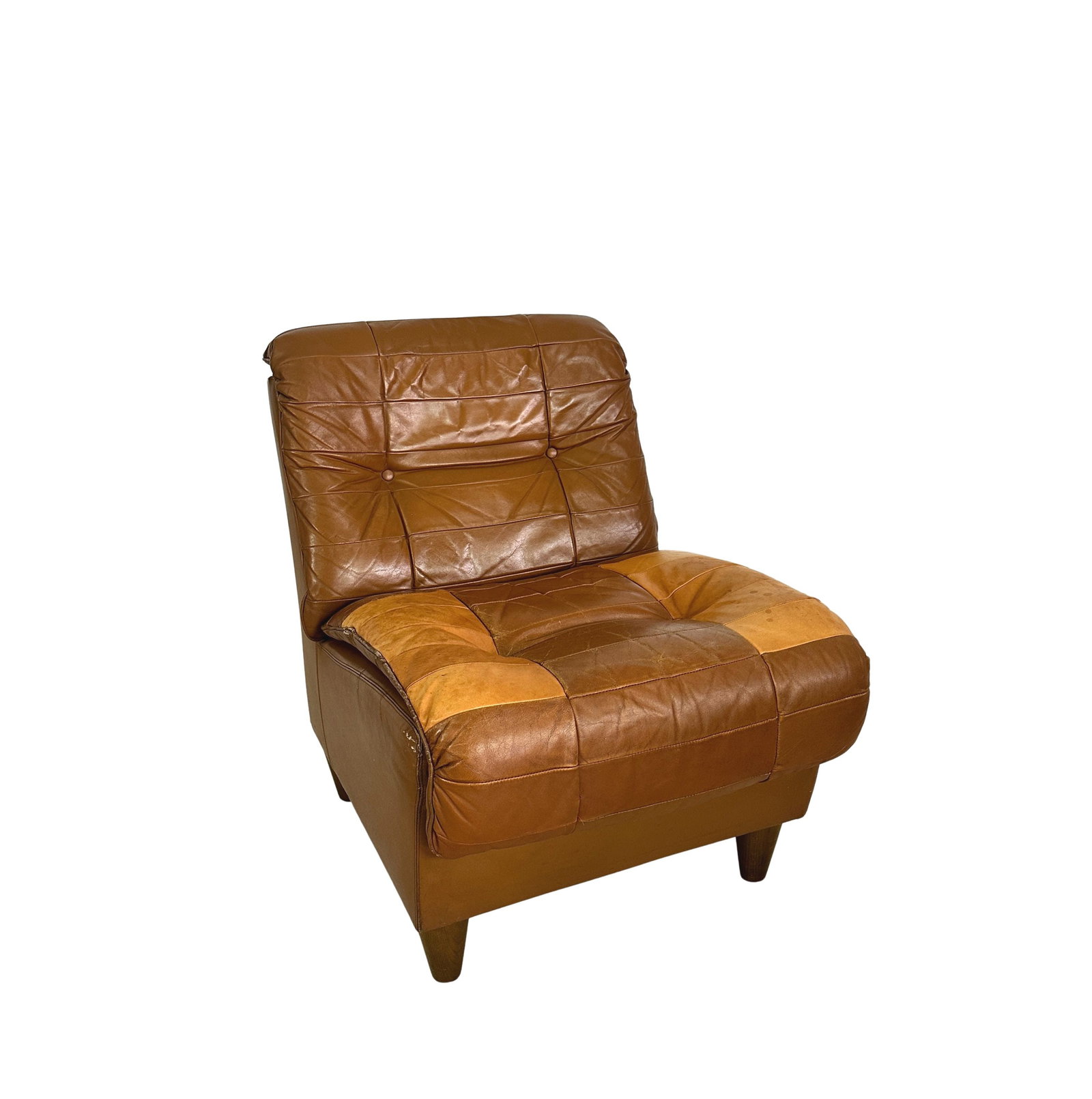 ITALIAN LOUNGE CHAIR, 1970s: Dimensions: H 31” x W 25” x D 31” x SH 18.7”. Vintage Italian lounge chair in cognac leather patchwork from the 1970s. Can be combined for a set.