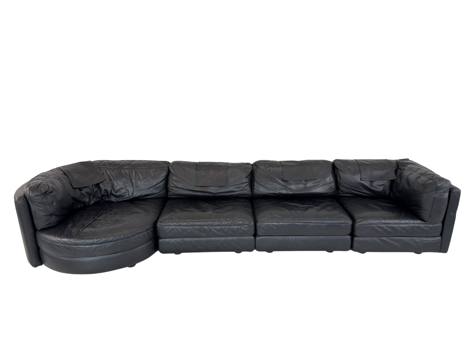 LIGNE ROSET MODULAR SOFA: Dimensions: H 27” x W 34.3” x D 35” x SH 16”. Vintage black leather modular sofa designed by Ligne Roset in the 1980s with loose padded cushions. Consist of 2 lounge chairs, 1 