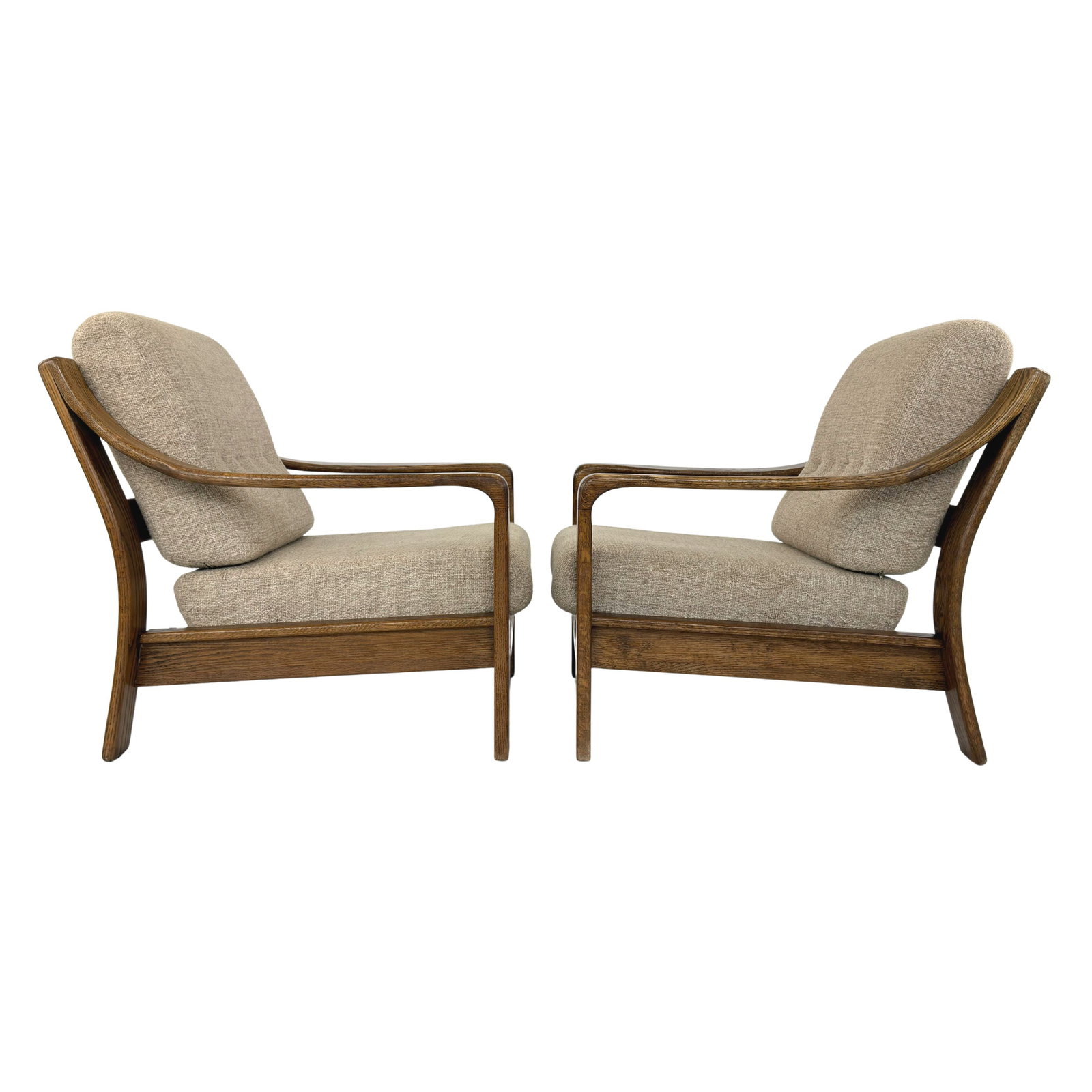 EASY CHAIRS MANNER OF JUUL KRISTENSEN, A PAIR: Dimensions: H 34” x W 30” x D 33 ” x SH 16”. Pair of Vintage Danish easy chairs manner of Juul Kristensen with oak frames and beige fabric loose padded cushions.