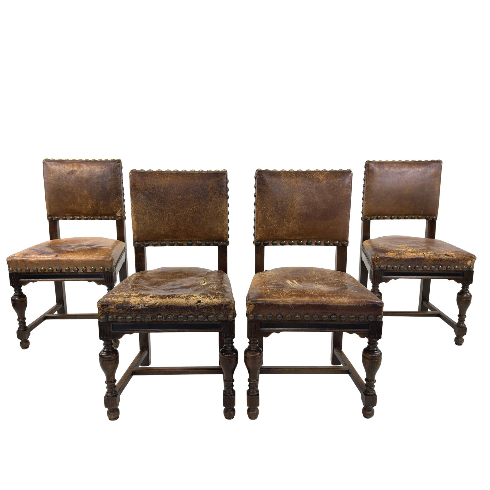 (4) SPANISH LEATHER DINING CHAIRS: Dimensions: H 35” x W 18.5” x D 19” x SH 19”. Set of 4 Antique Spanish carved wood dining chairs with brown leather seats and backs.
