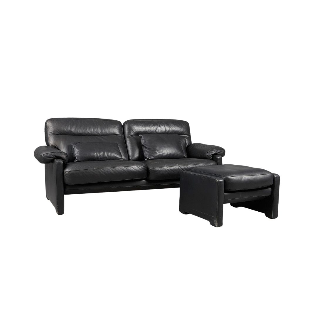 DE SEDE DS-70 SOFA WITH OTTOMAN: Dimensions: H 34.6” x W 78.7” x D 35.4” x SH 18.5”. Vintage Swiss black leather two-seater sofa with ottoman DS-70 from De Sede, 1970s. Dimensions: (ottoman) H 16.7" x W 26.3" 