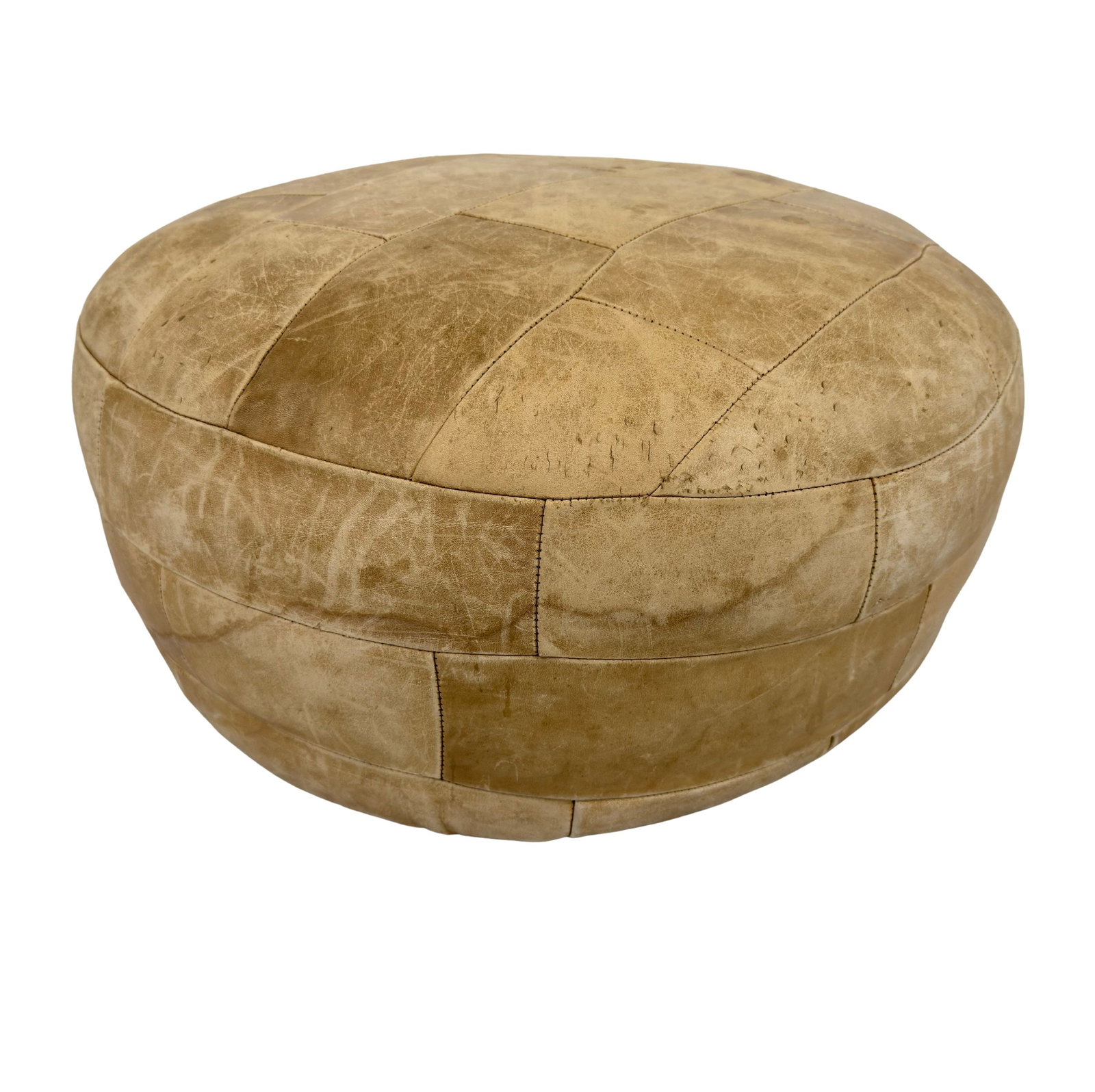 DE SEDE LEATHER POUF: Dimensions: H 13” x W 20”. Vintage beige leather patchwork pouf by De Sede.