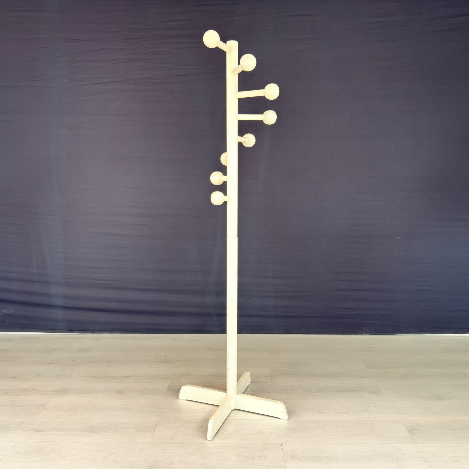 VINTAGE STANDING COAT RACK: Dimensions: H 70.5” x W 23”. Vintage white painted standing coat rack with 8 circular hooks.