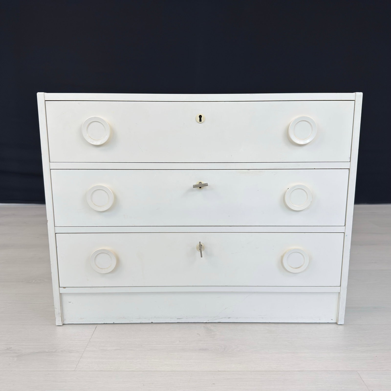 VINTAGE ITALIAN CHEST OF DRAWERS: Dimensions: H 23” x W 29.5” x D 15.3”. Vintage Italian white painted chest of drawers with 3 drawers with wooden handles, 2 keys included.