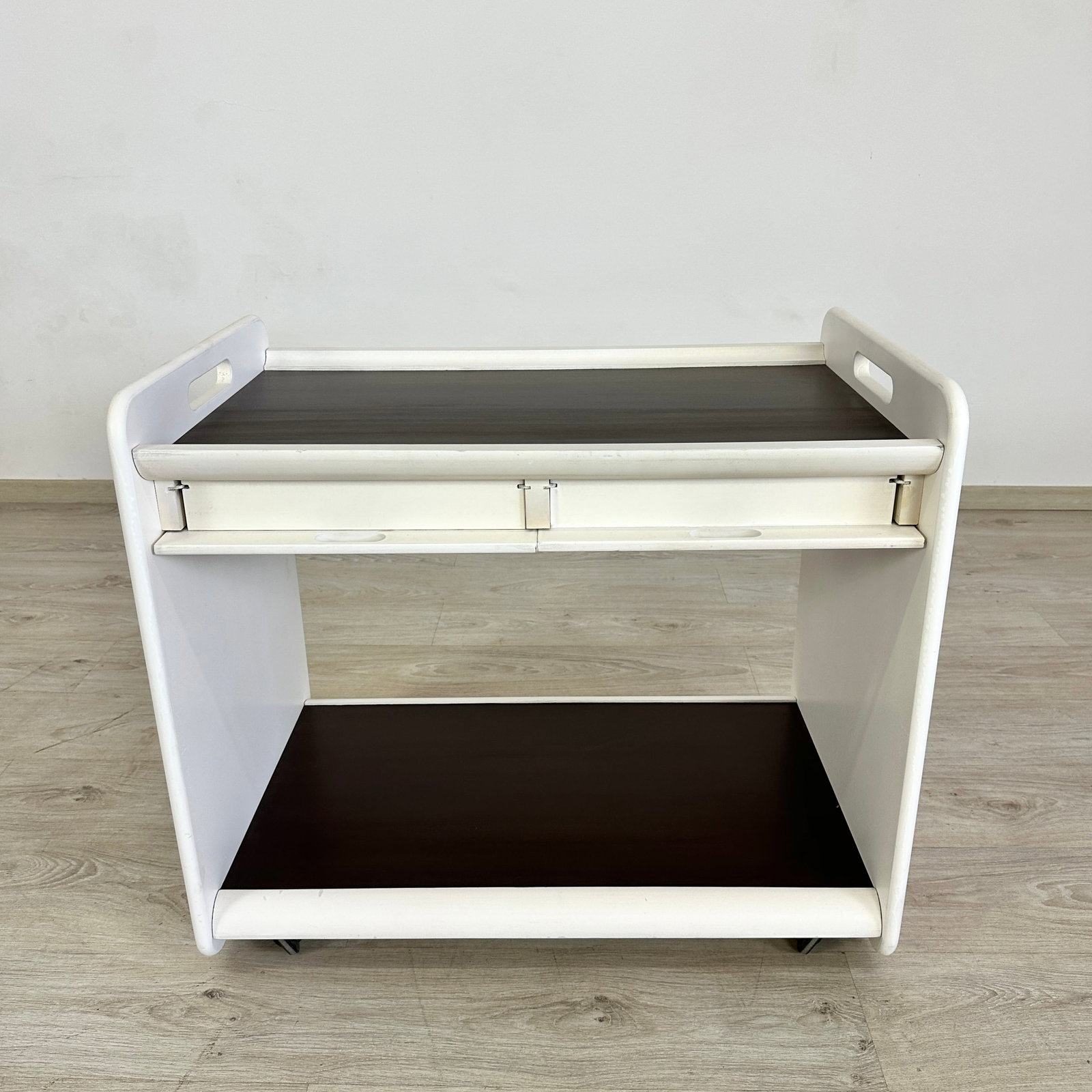 VINTAGE BAR CART: Dimensions: H 25.7” x W 31.5” x D 20.3”. Vintage bar cart painted in white with 2 shelves and 2 small drawers.