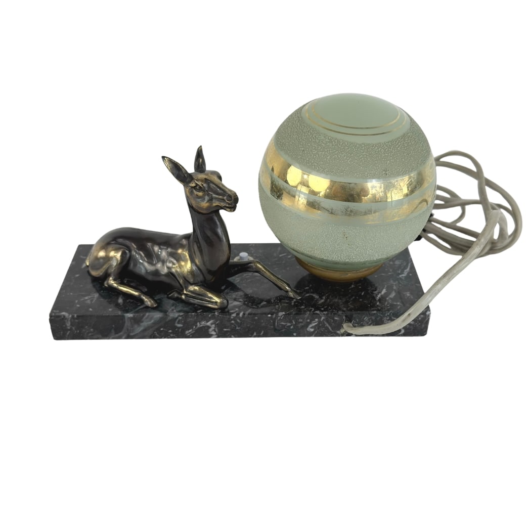 FRENCH ART DECO TABLE LAMP: Dimensions: H 5.3” x W 8.7” x D 3”. Vintage French Art Deco table lamp with spelter deer figure on a marble base with glass globe shade.