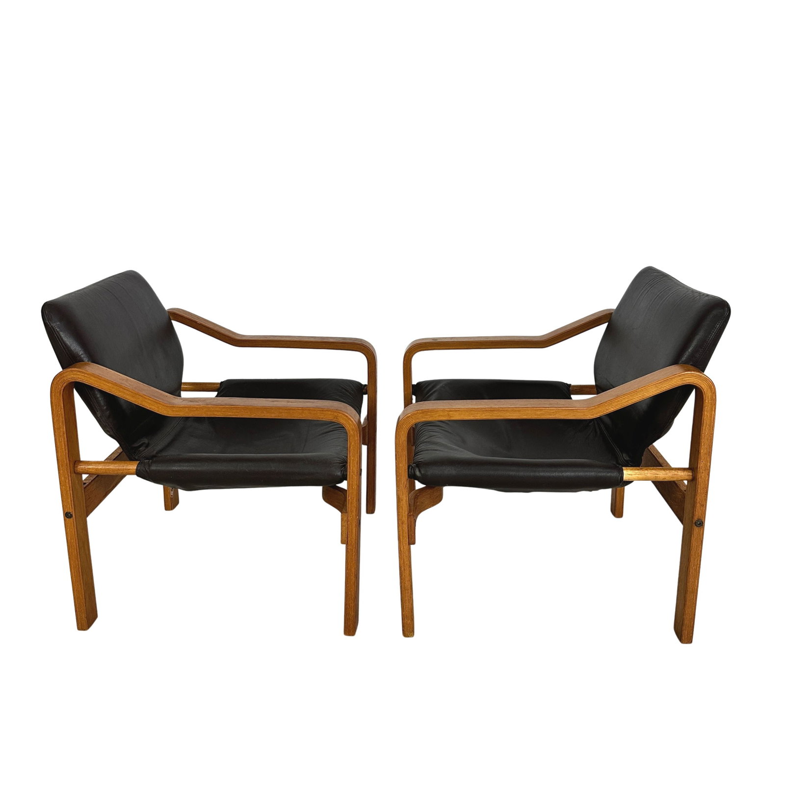 JANOS BODNAR LOUNGE CHAIRS, A PAIR: dimensions: H 27” x W 24.5” x D 23.7” x SH 14.5”. Pair of Vintage European lounge chairs in dark brown leather designed by Janos Bodnar in the 1970s.