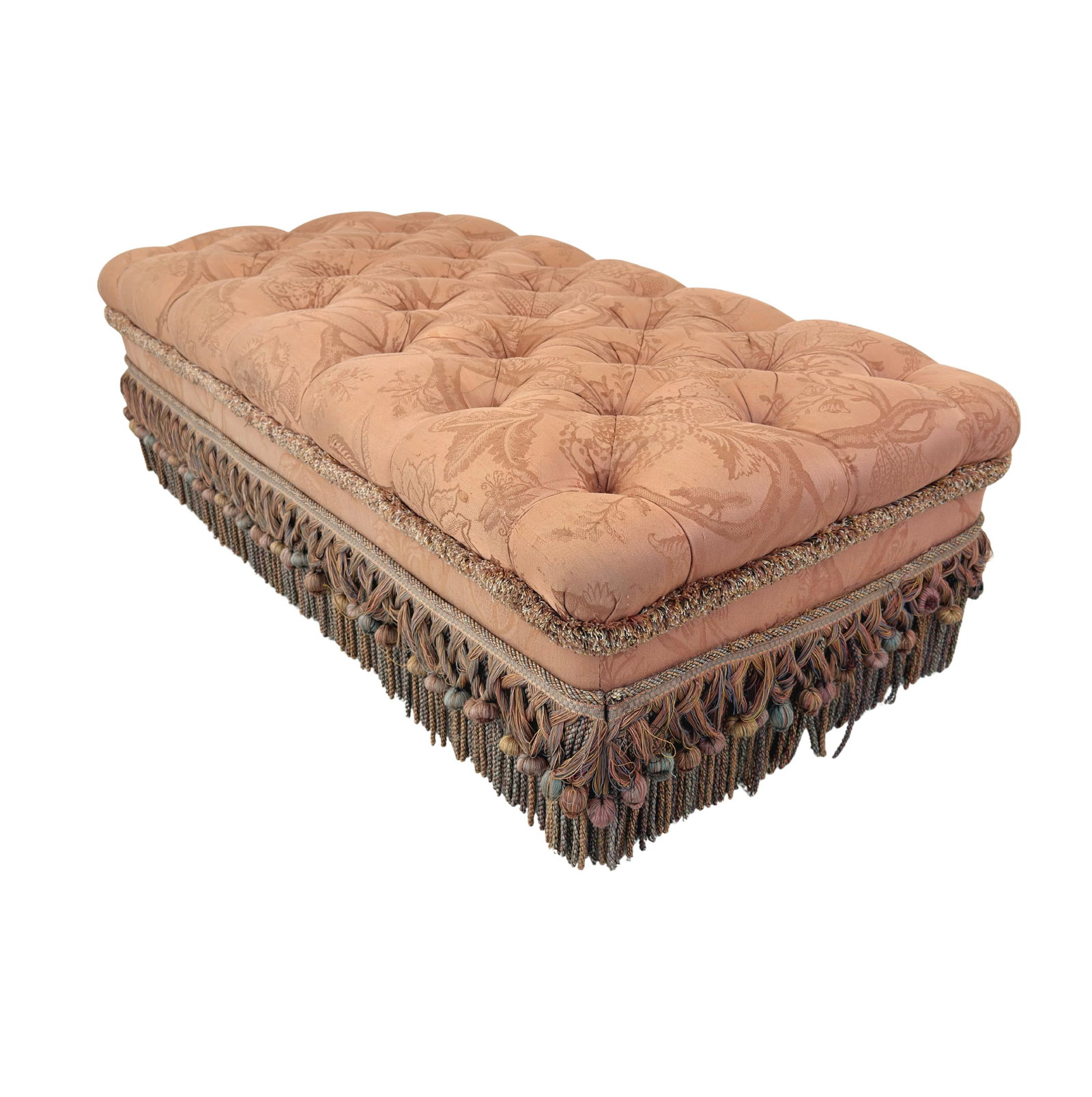 VINTAGE FRENCH FOOTSTOOL: Dimensions: H 15.5” x W 49” x D 25”. Vintage French footstool with original pink upholstery with fringes, legs on casters.