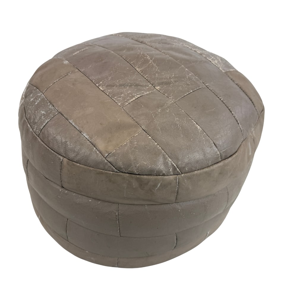 LEATHER POUF BY DE SEDE: Dimensions: H 13” x W 19.3”. Vintage patchwork brown leather pouf from De Sede.