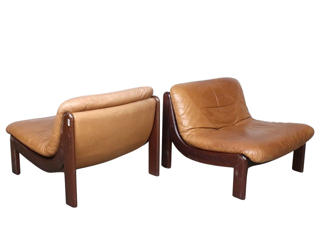 GERMAN LOUNGE CHAIRS MANNER OF CARL STRAUB, A PAIR: Dimensions: H 26.3” x W 31.4” x D 35.4” x SH 14.5”. Pair of Vintage German oak lounge chairs manner of Carl Straub with brown leather loose padded cushions.