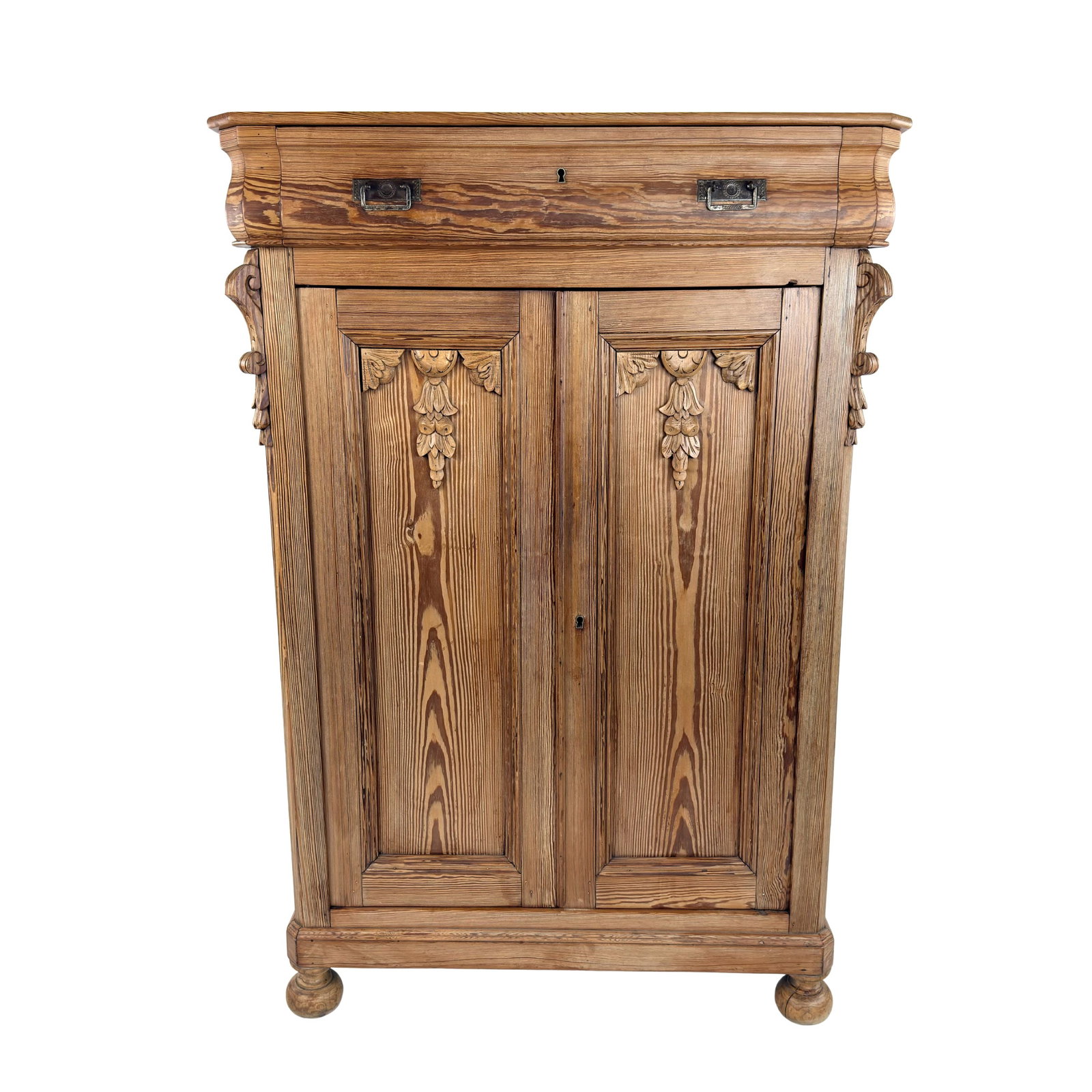 PINE VERTIKO CABINET: Dimensions: H 57” x W 39” x D 19”. Vintage carved pine Vertiko kitchen cabinet with a drawer and a cupboard with 3 shelves inside.