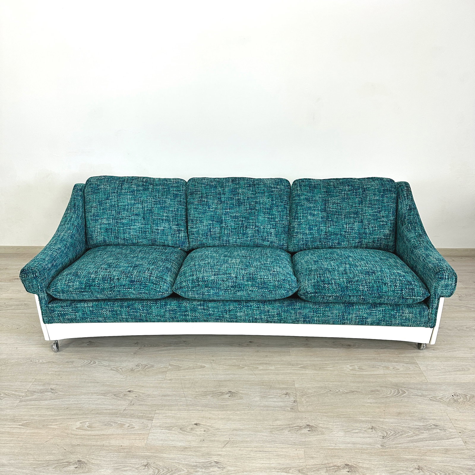 ITALIAN SPACE AGE SOFA: Dimensions: H 28” x W 82 ” x D 31.3” x SH 17”. Vintage Italian Space Age three-seater sofa with white frame, newly upholstered in blue textured fabric. Front legs on casters.