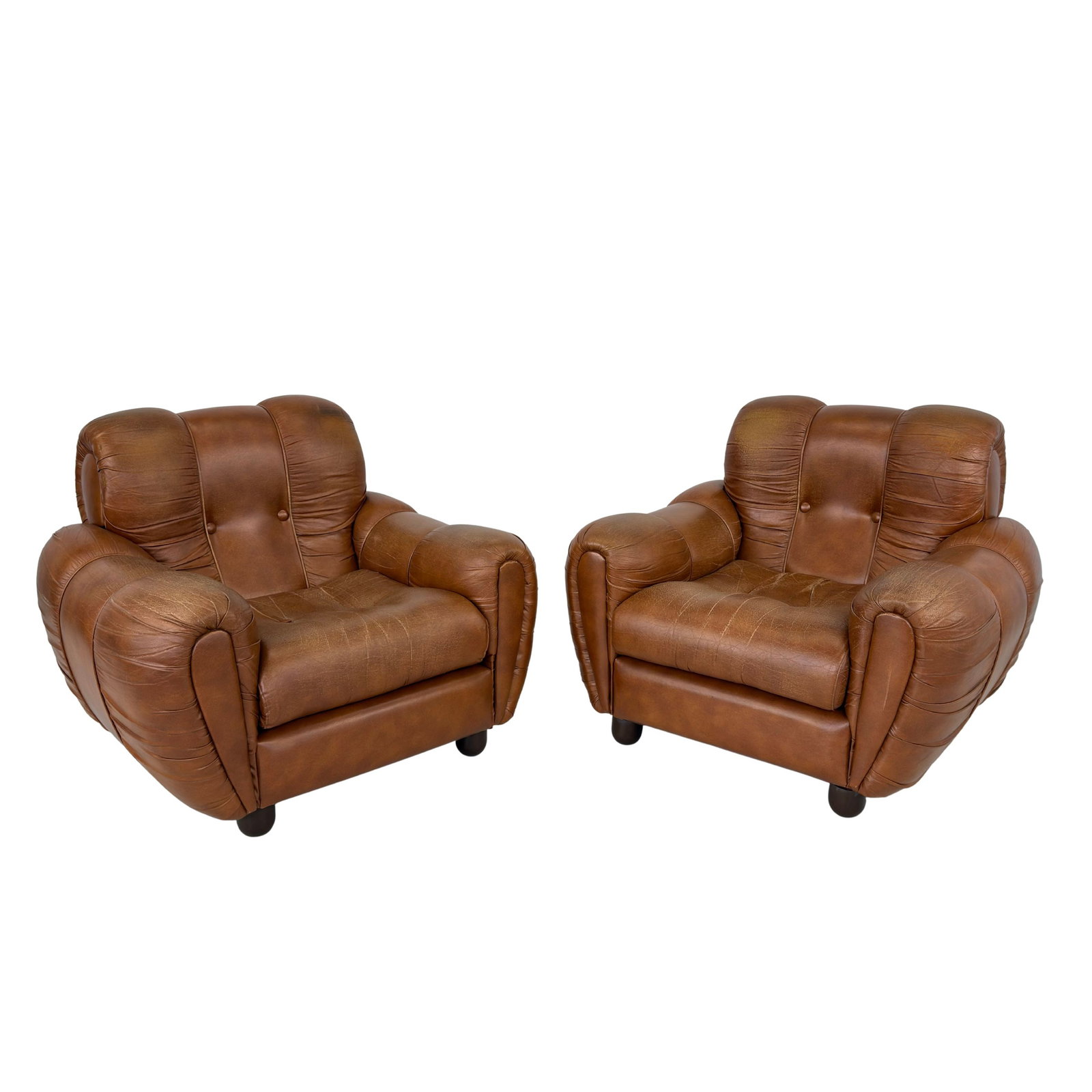 VINTAGE ITALIAN ARMCHAIRS, A PAIR: Dimensions: H 33” x W 37.5” x D 36” x SH 16.5”. Pair of Vintage Italian Space Age cognac faux leather lounge chairs with loose padded cushions.