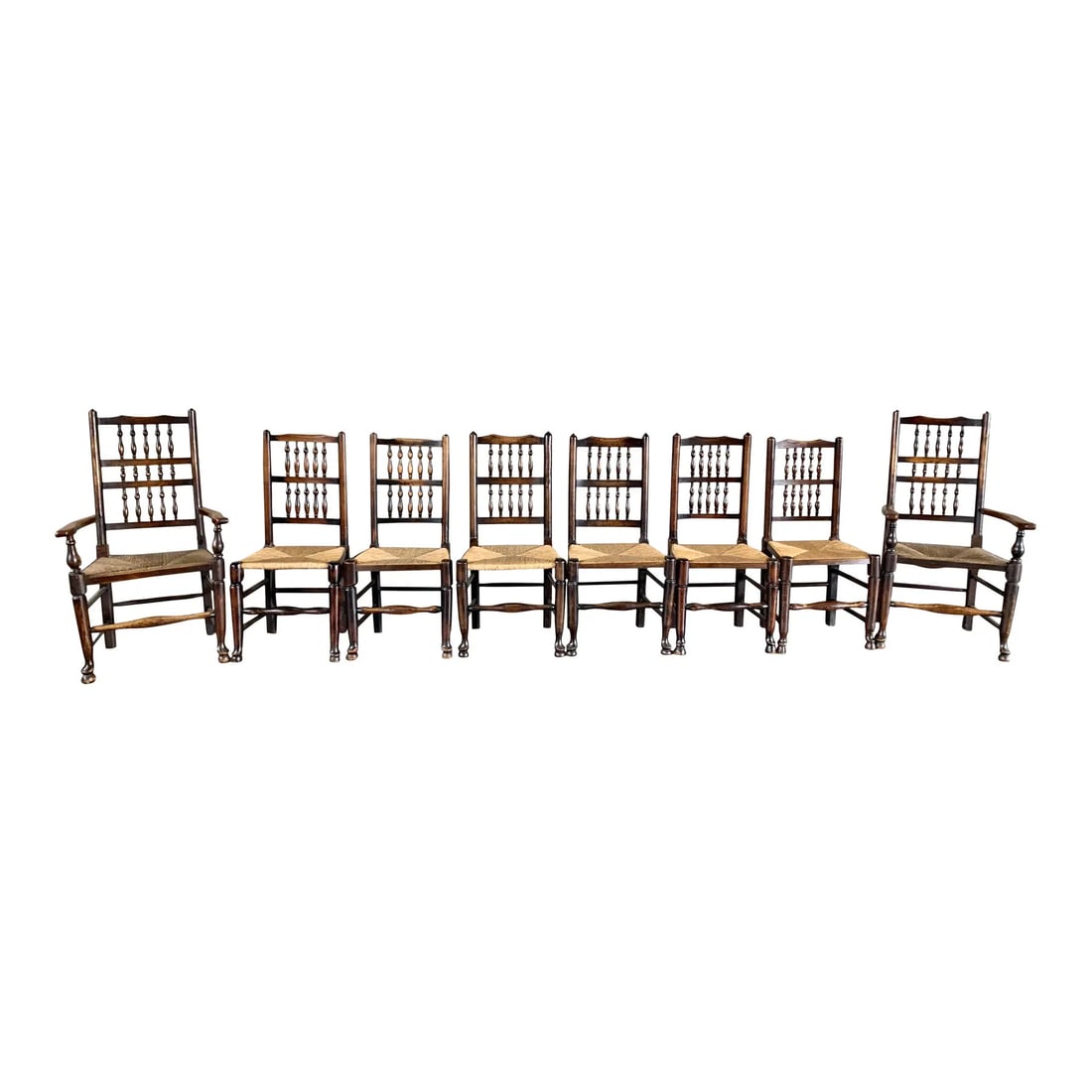 (8) ANTIQUE 18c SPINDLE BACK CHAIRS: Dimensions: H 39.3” x W 19.6” x D 15.7” x SH 18”. Set of 8 Antique 18C Dutch spindle back pine dining chairs with rush seats, two of the chairs are with armrests. Dimensions: