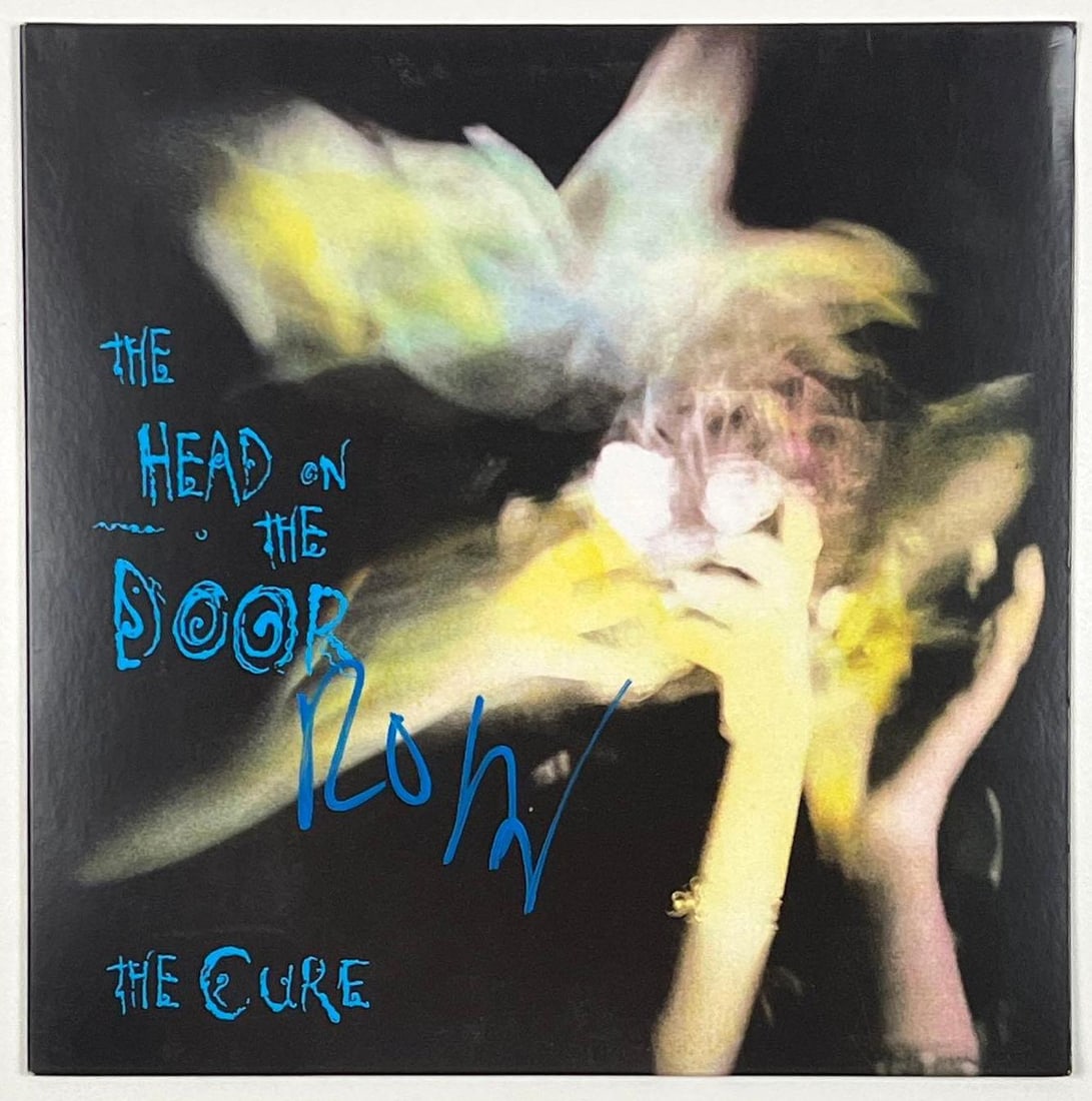 The Cure: Robert Smith "The Head on the Door" Album (Beckett/BAS Authentication): “The Head on the Door” album signed on the cover in blue paint pen by The Cure's Robert Smith. In fine condition. Record is not included. Item presents a Beckett/BAS Authenticat