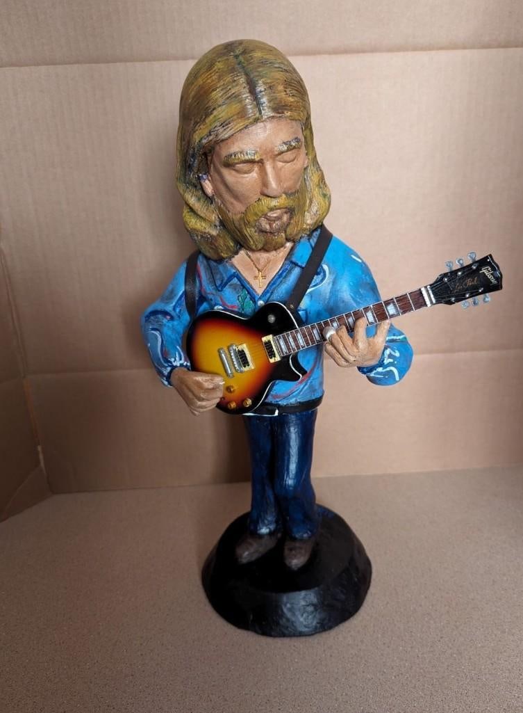 Duane Allman Hand-Crafted 17" Statue By Sculptor Ron Marko: Experience the exceptional: an exclusive chalkware/plaster sculpture capturing the essence of Duane Allman, legendary guitarist of the Allman Brothers. Crafted by artist Ron Marko, this statue stands