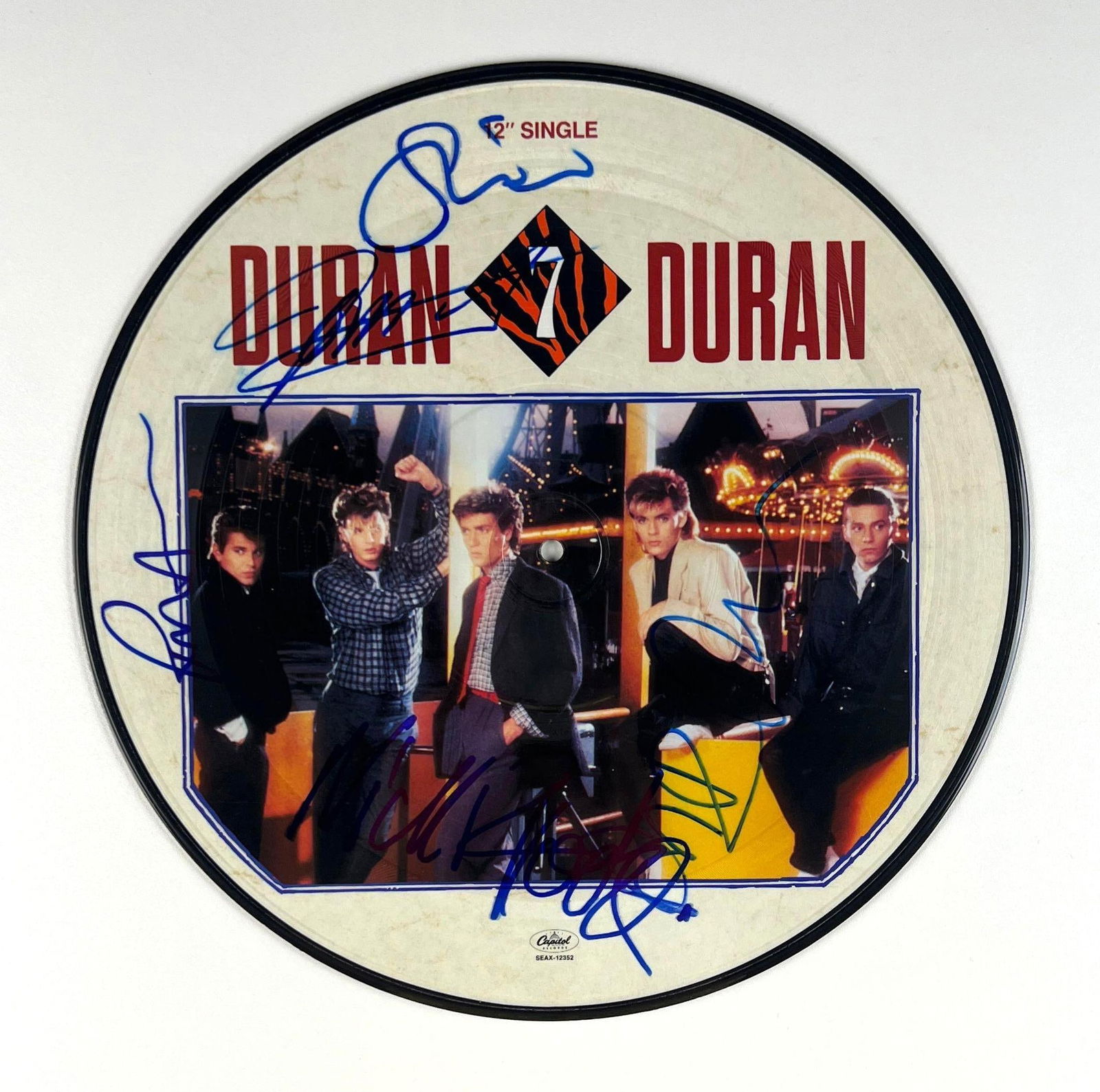 Duran Duran In-Person Group Signed "The Reflex" 12" Single Picture Disc Record (JSA LOA): “The Reflex” 12" single picture disc signed on the cover in blue felt tip by all five members of Duran Duran: Nick Rhodes, Roger Taylor, Simon Le Bon, John Taylor, and Andy Taylor. In