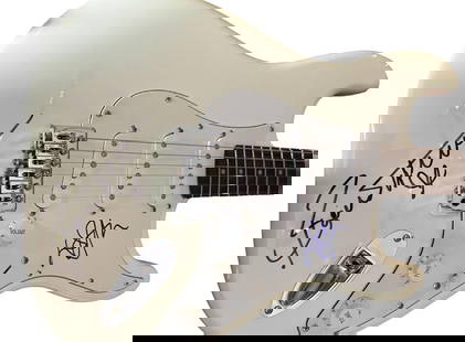 Elton John & Bernie Taupin Dual-Signed Fender Squier Stratocaster Guitar (JSA LOA): White Fender Squier stratocaster electric guitar signed on the pickguard in blue felt tip marker by Elton John and on the guitar body in black felt tip marker by Bernie Taupin. In fine condition.