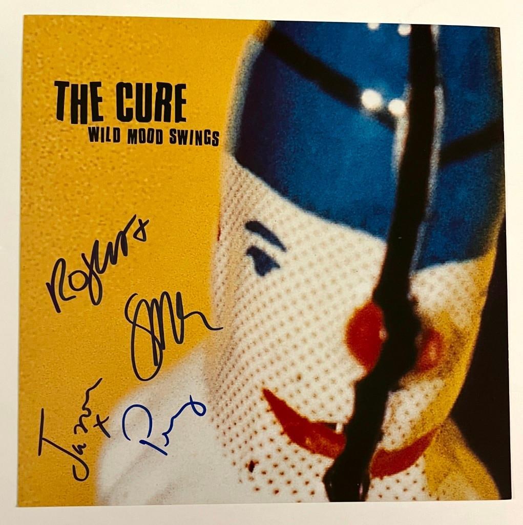 The Cure Group Signed "Wild Mood Swings" Album Flat (4 Sigs) (Beckett/BAS Authentication): “Wild Mood Swings” album flat signed on the cover in blue felt tip by The Cure: Robert Smith, Simon Gallup, Jason Cooper, and Pearl Thompson. In fine condition. Flat only; record