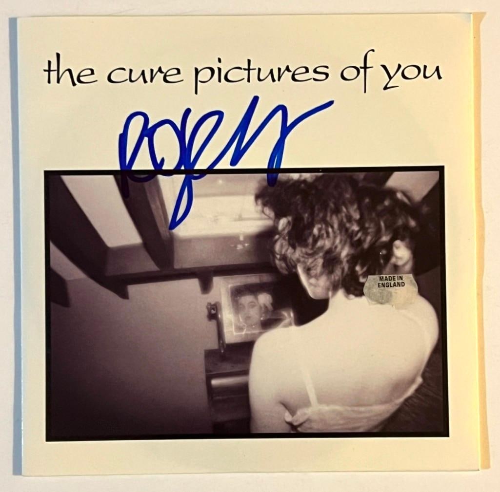 The Cure: Robert Smith In-Person Signed "Pictures of You" 45 RPM Record (Beckett/BAS COA): "Pictures of You" 45 record signed on the cover in blue felt tip marker by Robert Smith. In fine condition. Record is included. Accompanied by a Beckett cert. Obtained in-person.