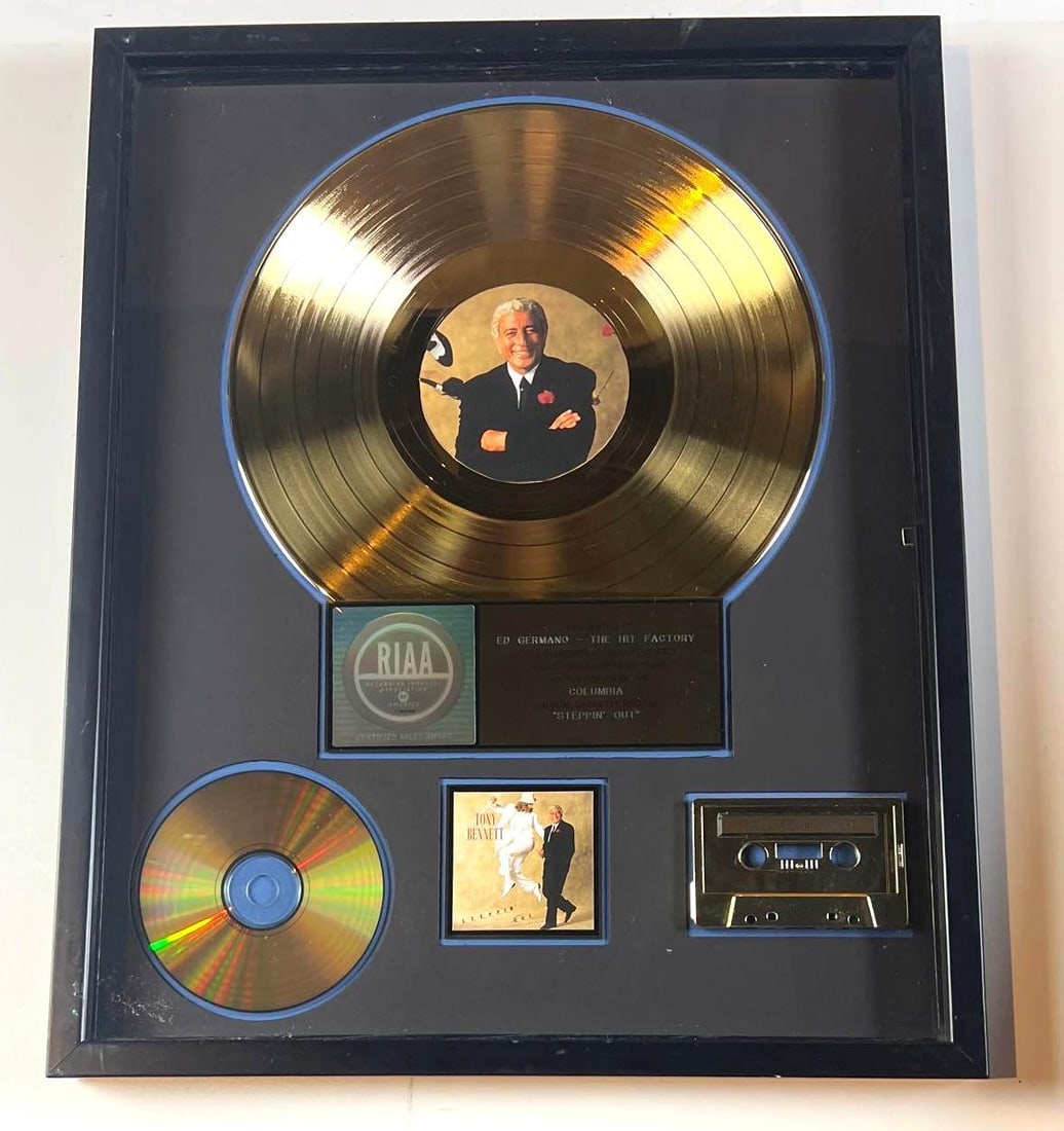 Tony Bennett "Steppin' Out" RIAA Gold Album Sales Award Presented to The Hit Factory: RIAA Gold Sales Award presented to Ed Germano / The Hit Factory, commemorating the sale of more than 500,000 copies of Tony Bennett's album "Steppin' Out." This display features a gold-colored vinyl r