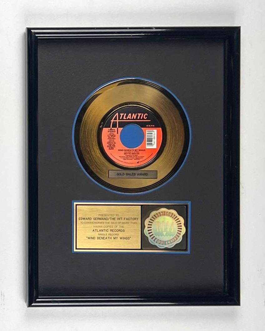 Bette Midler “Wind Beneath My Wings” RIAA Gold Single Sales Award Presented to The Hit F: This is an RIAA Certified Gold Sales Award presented to Edward Germano and The Hit Factory to commemorate the sale of more than 500,000 copies of the Atlantic Records single "Wind Beneath My Wings." T