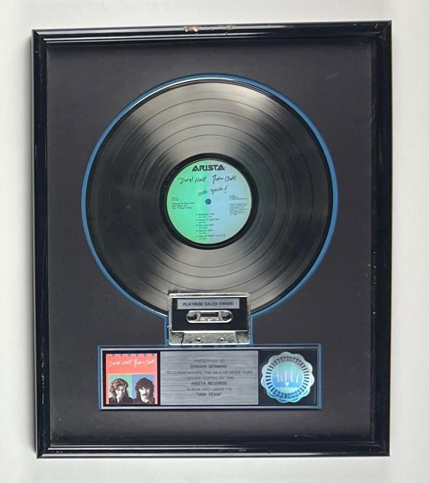 Daryl Hall & John Oates "Ooh Yeah!" RIAA Platinum Album Sales Award Presented to Ed Germano: This is an RIAA Certified Platinum Sales Award presented to Ed Germano to commemorate the sale of more than 1,000,000 copies of the Arista Records album and cassette "Ooh Yeah!" The framed display, me