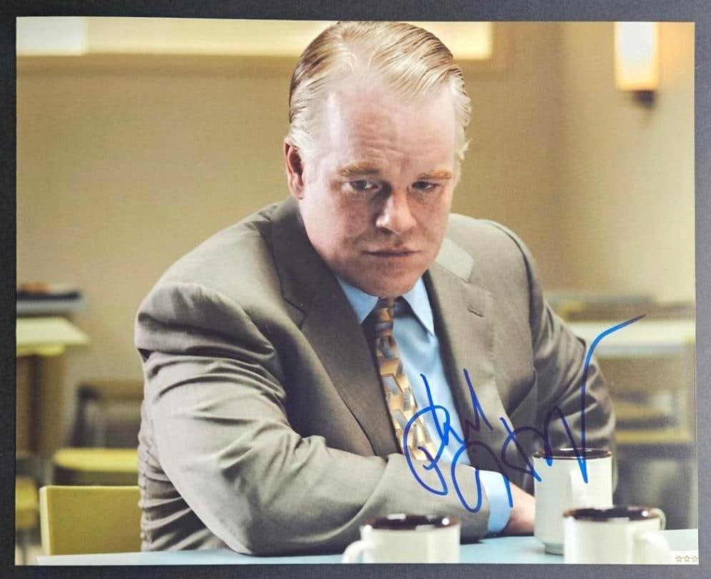 Phillip Seymour Hoffman In-Person Signed Photo (Third Party Guaranteed): Color 10" x 8" photo signed in blue felt tip marker by Phillip Seymour Hoffman. In fine condition. Obtained in-person. Provenance Eaton & Brennan Auctions guarantees this lot to pass Third-Party Authe