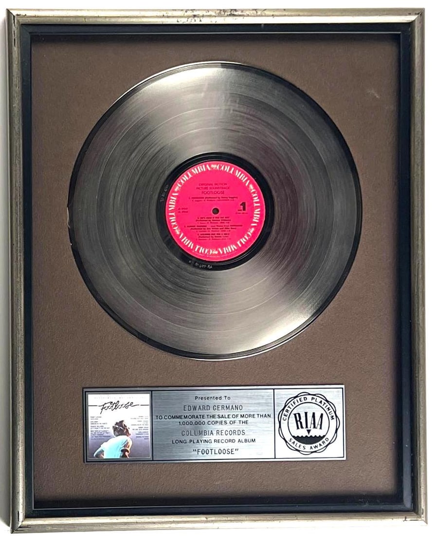 "Footloose" Platinum Sales Award Presented to Ed Germano: RIAA Certified Platinum Sales Award presented to Ed Germano to commemorate the sale of more than 1,000,000 copies of Kenny Loggins' Footloose album, released by Columbia Records in 1984. The