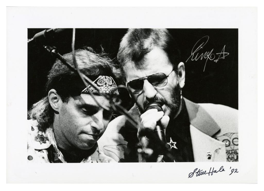 Ringo Starr Signed Liverpool Empire Photo with Steve Hale (Tracks COA): Black and white 8.2" x 11.6" photograph ofRingo StarrandNils Lofgrenperforming live at the Empire Theatre in Liverpool, England on July 6, 1992. Signed in silver felt tip pen by Ringo Starr. The photo