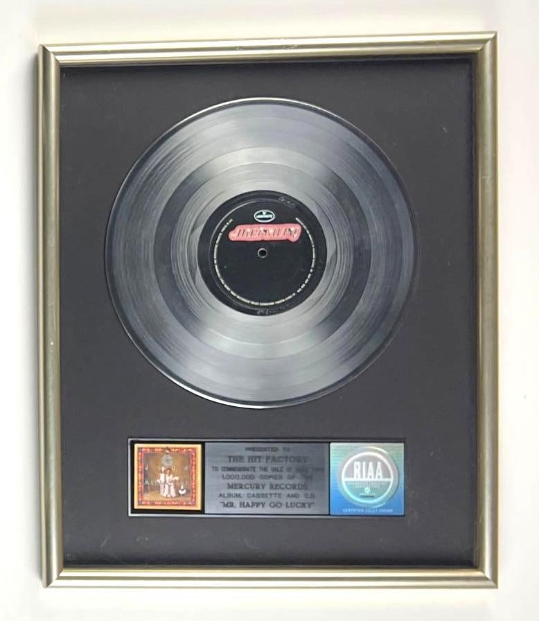 John Mellencamp “Mr. Happy Go Lucky” RIAA Platinum Album Sales Award Presented to The Hi: This is an RIAA Certified Platinum Sales Award presented to The Hit Factory to commemorate the sale of more than 1,000,000 copies of the Mercury Records album, cassette, and CD "Mr. Happy Go Lucky" by