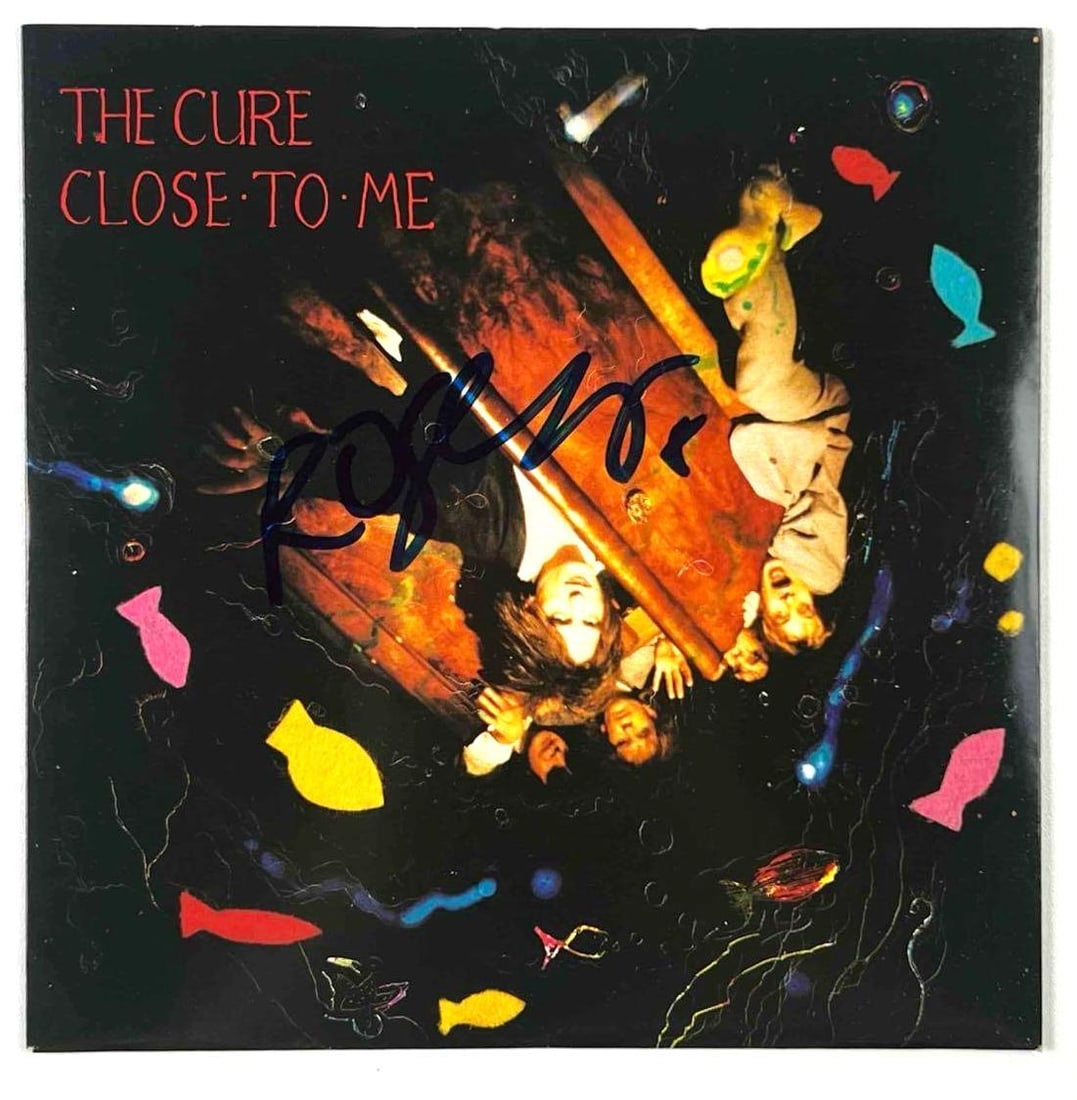 The Cure: Robert Smith In-Person Signed "Close to Me" 45 RPM Single Sleeve (Beckett Authentication): "Close to Me" 45 RPM single sleeve signed on the cover in black felt tip marker by The Cure's frontman Robert Smith. Measuring approximately 7” x 7” and in very good condition. Record is i