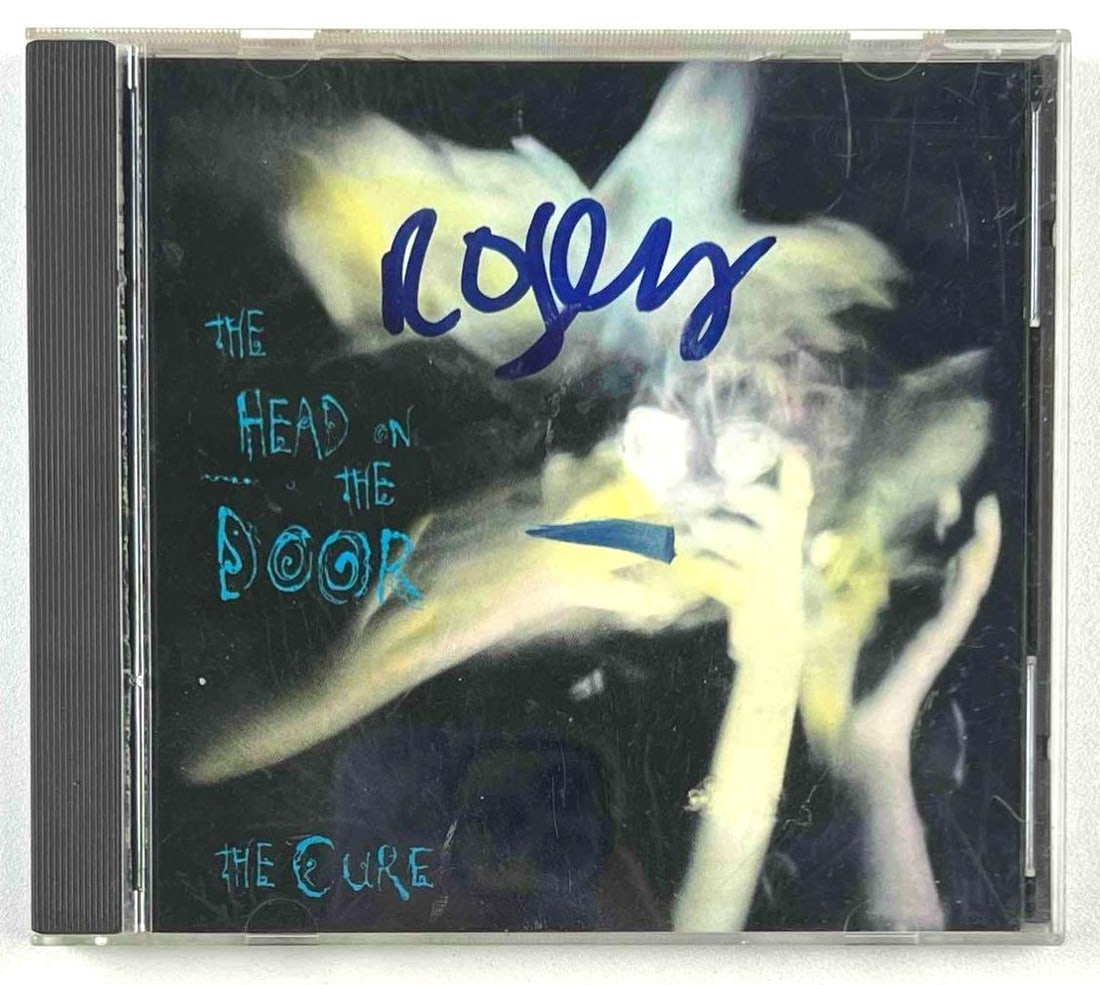 The Cure: Robert Smith Signed "The Head on the Door" CD (Beckett Authentication): "The Head on the Door" CD signed on the front insert in blue felt tip marker by The Cure’s frontman Robert Smith. CD and case are included, measuring approximately 5” x 5.5” overall.