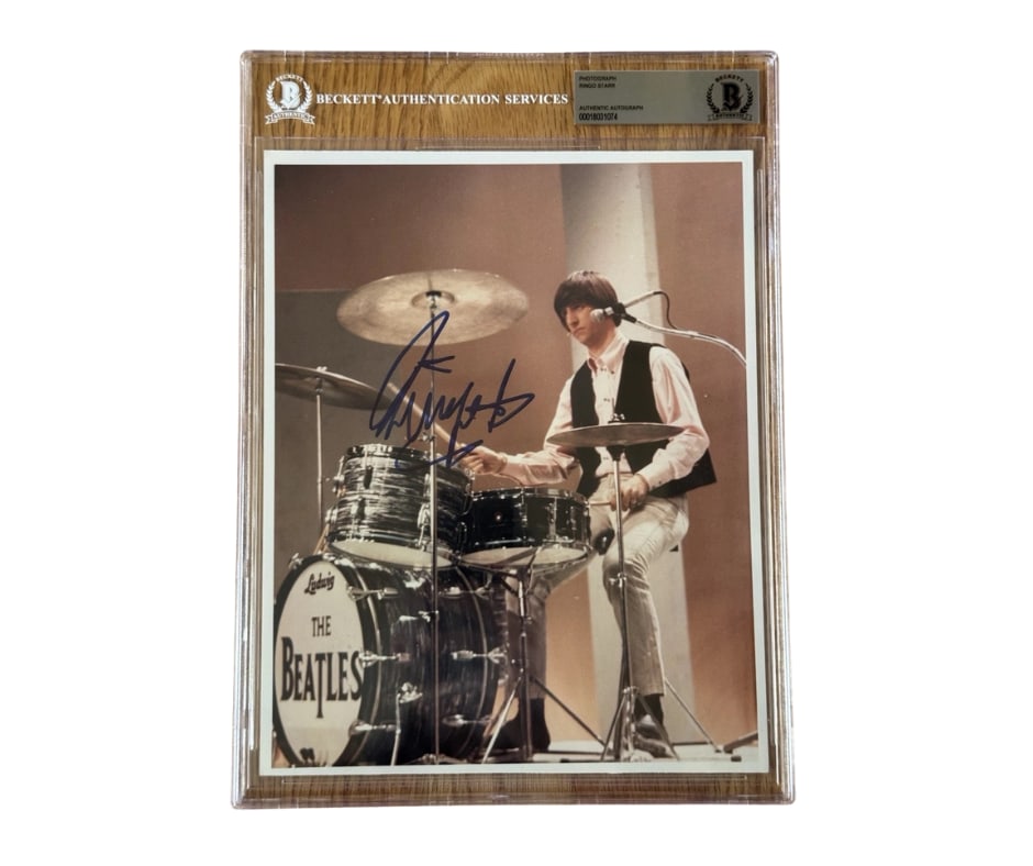 Beatles: Ringo Starr Signed 10" x 8" Photo Playing the Drums (Beckett/BAS Encapsulated): Vibrant 10" x 8" color photo of Ringo Starr performing behind his classic Ludwig drum kit, boldly signed in felt tip marker. A powerful image capturing Ringo in action during the Beatles era, presente