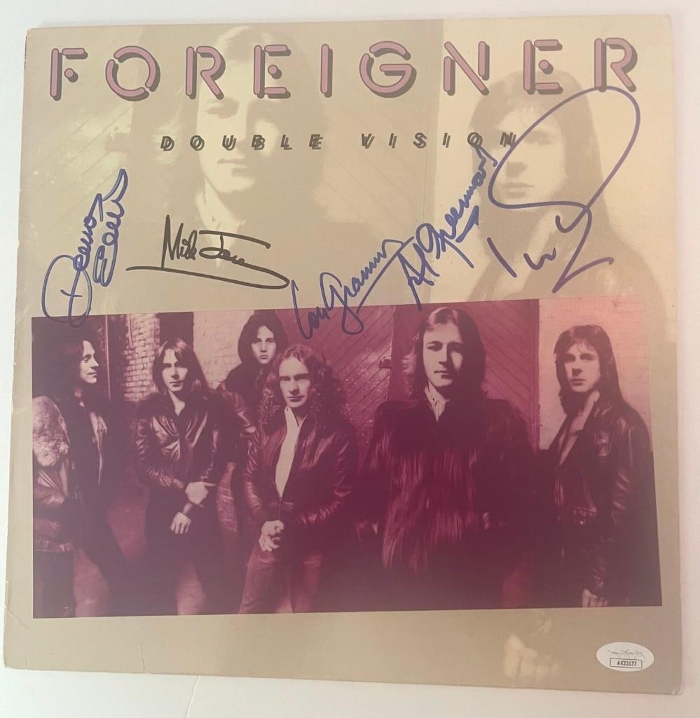 Foreigner Group Signed "Double Vision" Album (5 Sigs) (JSA Authentication): Foreigner "Double Vision" LP cover signed by five classic-era band members: Mick Jones, Lou Gramm, Al Greenwood, Ian McDonald, and Dennis Elliott. All signatures appear on the front cover in bold felt