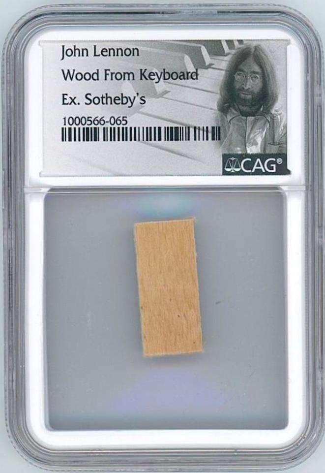 John Lennon Wood Fragment from Personally Owned Keyboard (CAG Encapsulated): Wood fragment, 0.5" x 1" taken from a late 19th-century Mason & Hamlin pump organ personally owned by John Lennon. The instrument was sold at Sotheby’s on June 23, 1984 as part of the ̶