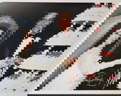Priscilla Presley In-Person Signed 11" x 14" Wedding Photo with Elvis (JSA Sticker): Color 14" x 11" photo of Priscilla Presley and Elvis Presley cutting their wedding cake, signed in silver felt tip marker by Priscilla Presley. A classic and beautifully composed image from one of pop