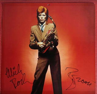 David Bowie & Mick Rock Dual-Signed "Wild Ones" Calendar (1/30) (JSA Authentication): Color 12" x 12" "Wild Ones" calendar page signed in black felt tip marker by David Bowie and photographer Mick Rock. Bowie adds the inscription "Wild Rock." Hand-numbered 1/30, these were given away o