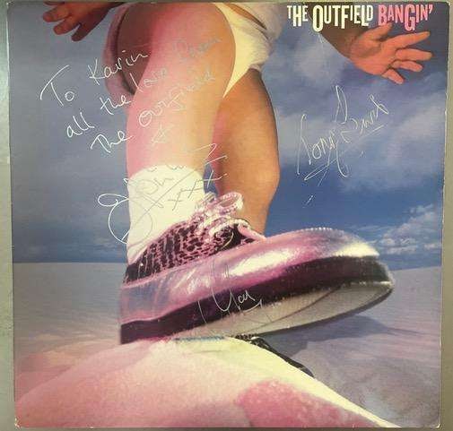 The Outfield Fully Group Signed "Bangin’" Album (3 Sigs) (Third Party Guaranteed): "Bangin’" album signed on the cover in silver felt tip marker by Tony Lewis, John Spinks, and Alan Jackman of The Outfield. Measuring approximately 12" x 12" and in very good condition, with a s