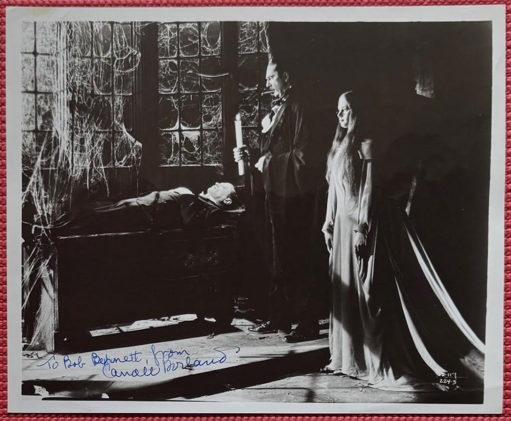Caroll Borland Signed 10" x 8" Photo (PSA DNA Authentication): Black-and-white 10" x 8" photo signed in blue ballpoint pen by actress Caroll Borland, who also inscribed "To Bob Bennett" before her signature. The photo pictures her with actor Bela Lugosi. In fine