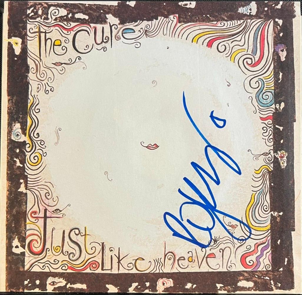 The Cure: Robert Smith Signed "Just Like Heaven" 45 (Beckett/BAS Authentication): "Just Like Heaven" 45 signed on the cover in blue felt tip marker by The Cure frontman Robert Smith. Measuring approximately 7" x 7" and in fine condition. Record is included. Authenticated by Beckett