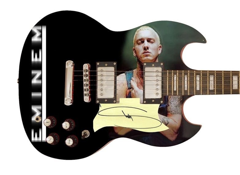 Eminem Graphics SG-Style w/ Custom-Made Signed Pickguard (REAL Authentication): Eminem graphics SG-style guitar signed on the custom-made pickguard in black felt tip marker by musician Eminem. Measuring 41” x 17” x 3” and in fine condition. Accompanied by a