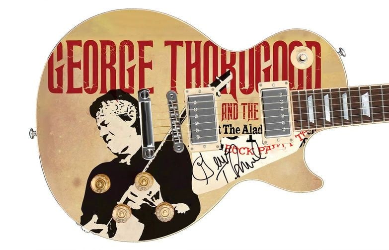 George Thorogood Graphics Les Paul-Style Guitar w/ Custom-Made Signed Pickguard (REAL Auth.): George Thorogood graphics Les Paul-style guitar signed on the custom-made pickguard in black felt tip marker by musician George Thorogood. Measuring 41” x 17” x 3” and in fine condit