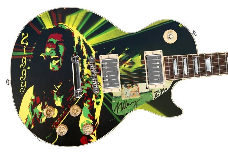 Ziggy Marley Graphics Les Paul-Style Guitar w/ Custom-Made Signed Pickguard (REAL Authentication): Ziggy Marley graphics Les Paul-style guitar signed on the custom-made pickguard in black felt tip marker by musician Ziggy Marley. Measuring 41” x 17” x 3” and in fine condition. Acc