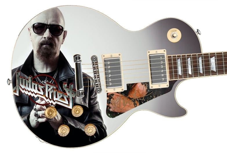 Judas Priest: Rob Halford Les Paul-Style Guitar w/ Custom-Made Signed Pickguard (REAL): Rob Halford graphics Les Paul-style guitar signed on the custom-made pickguard in gold felt tip marker by Judas Priest vocalist Rob Halford. Measuring 41” x 17” x 3” and in fine cond
