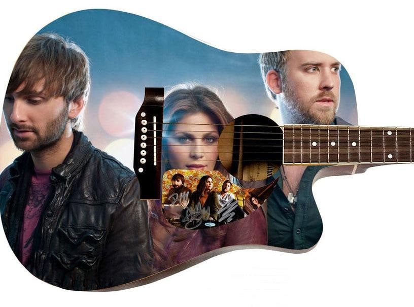 Lady Antebellum Graphics Dreadknought-Style Guitar w/ Custom-Made Signed Pickguard (3 Sigs) (REAL): Lady Antebellum graphics Dreadknought-style guitar signed on the custom-made pickguard in silver felt tip marker by Lady Antebellum bandmembers Charles Kelley, Hillary Scott, and Dave Haywood. Measuri