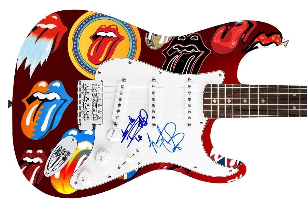 Rolling Stones: Keith Richards & Charlie Watts Graphics Fender Stratocaster Guitar (REAL): The Rolling Stones graphics Fender Squier Stratocaster guitar signed on the pickguard in blue felt tip marker by Rolling Stones bandmembers Charlie Watts and Keith Richards. Measuring 39R
