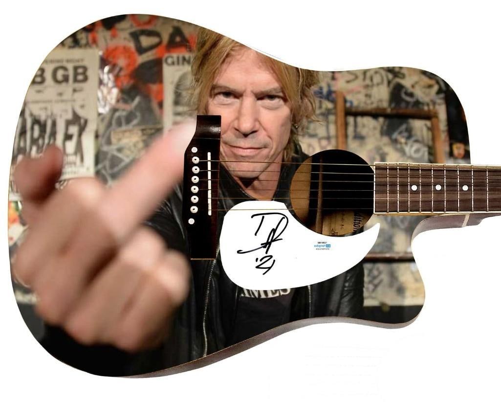 Guns N' Roses: Duff McKagan Graphics Dreadknought-Style Guitar w/ Custom-Made Pickguard (ACOA): Duff McKagan graphics Dreadknought-style acoustic guitar signed on the custom-made pickguard in black felt tip marker by Guns N' Roses bassist Duff McKagan. Measuring 41" x 20" x 5" and