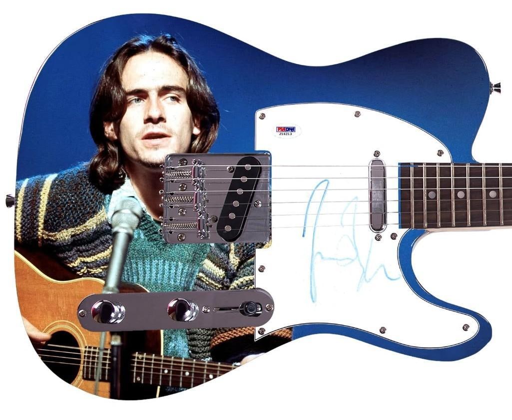 James Taylor Signed Graphics Telecaster-Style Guitar (PSA DNA Auth.): James Taylor graphics Telecaster-style guitar signed on the pickguard in blue felt tip marker by musician James Taylor. Measuring 38" x 12.75" x 1.75" and in fine condition, with some fading to a