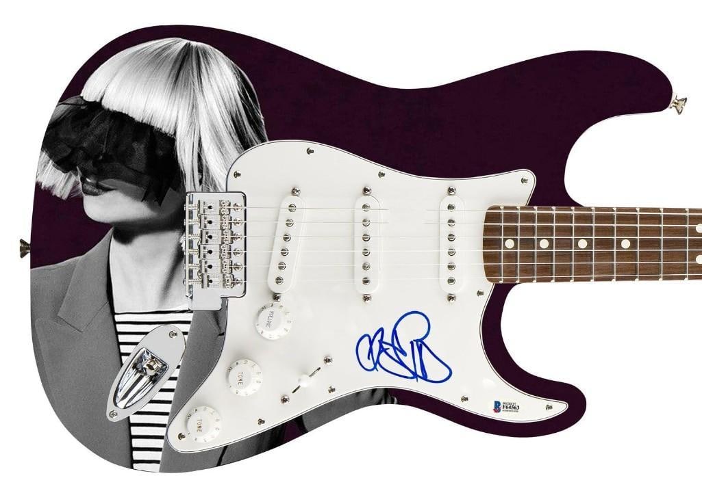 Sia Graphics Signed Stratocaster-Style Guitar (Beckett/BAS Authentication): Sia graphics Stratocaster-Style guitar signed on the pickguard in blue felt tip marker by singer Sia. Measuring 39" x 12.75" x 1.75" and in fine condition. Authenticated by Beckett/BAS, with